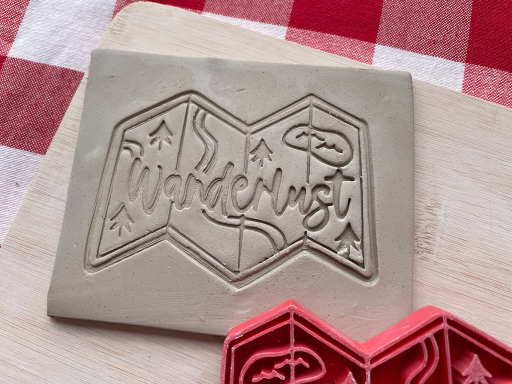 "Wanderlust" with map word pottery stamp, from the March 2024 Travel mystery box, 3d printed, multiple sizes available